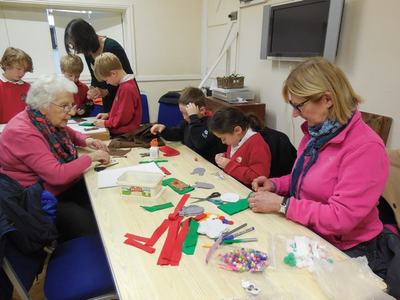 Valerie Jane and Evelyn helping pupils from Madley Primary to make a mini stocking on 22 November 