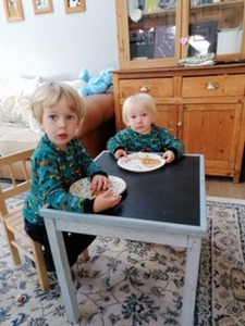 Joel and Drew look happy wearing tops made by grandma Evelyn