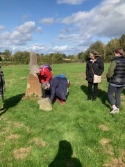 Rosemary and Maggie trying to read the writings on the stone, while Becky and Caroline watch on at Hellen’s Manor