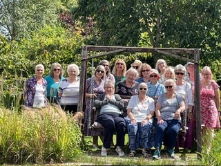 Members celebrating the clubs 20th anniversary. Not in the photo Jenny Cr and Sally B as they were elsewhere in the garden, taking the photo Jenny P